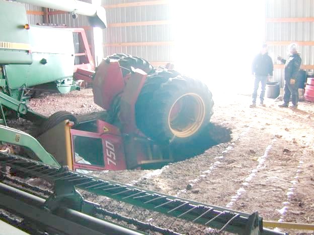 Farm equipment down a hole