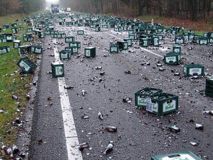 Crash scene - broken premium beer bottles cover a highway, having fallen off a truck.